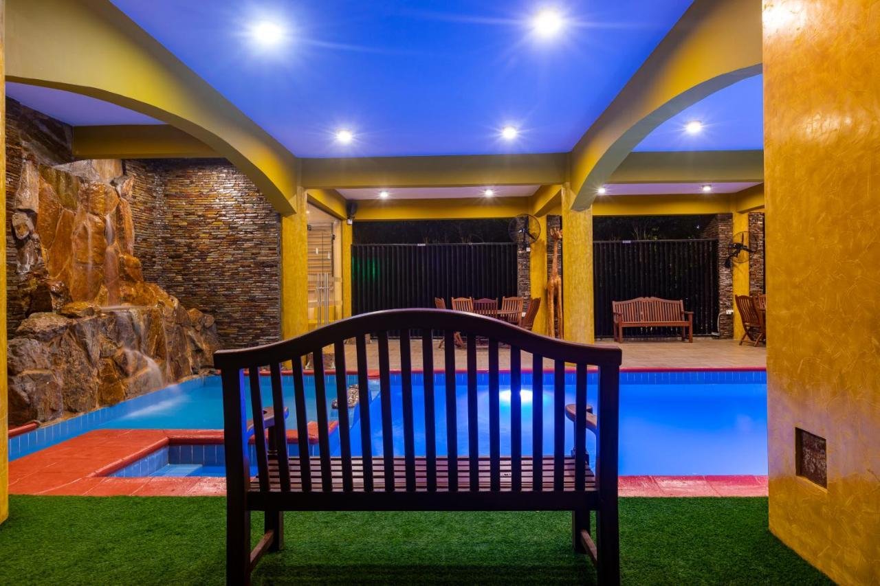 Poolside bench beside a stone wall